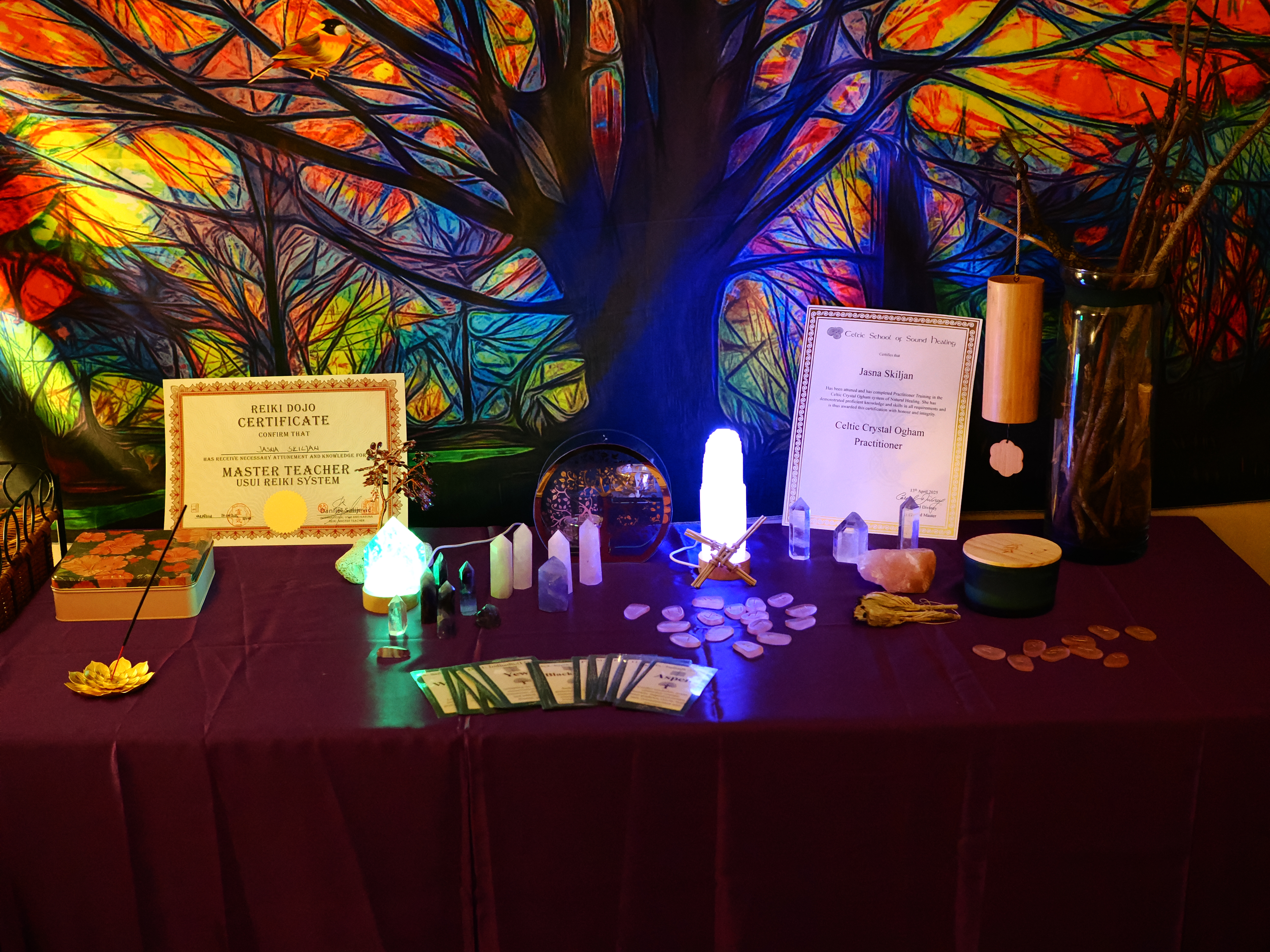 Red table with varoius Ogham healing crystals.